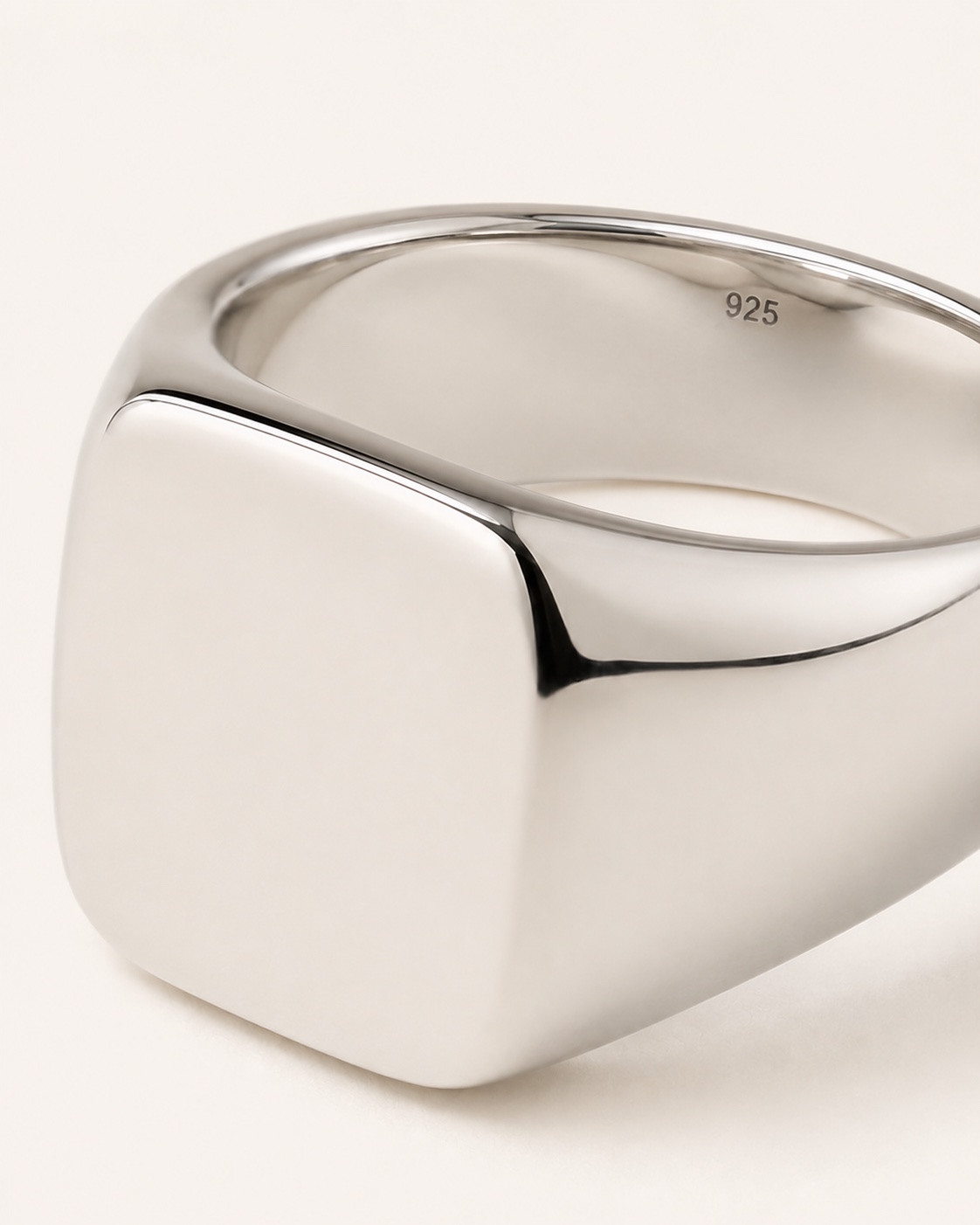 Close view of the polished silver Arc Signet Ring and its inner 925 mark