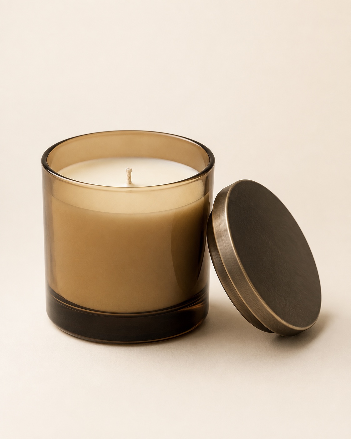 Dusk Candle in amber glass with a bronze-toned lid