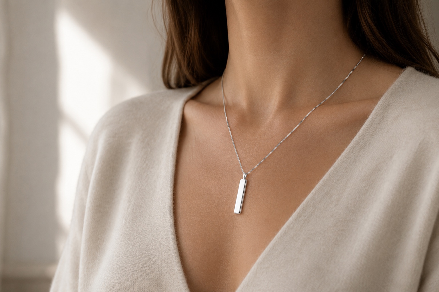 Line Pendant worn over a cream V-neck top