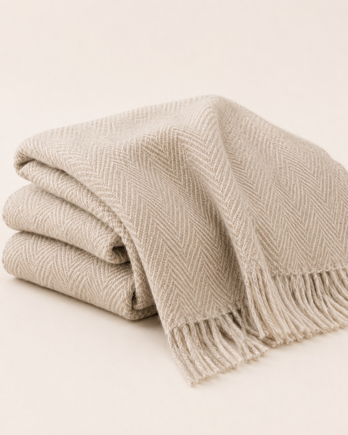 Folded Woven Throw in oat with a herringbone weave and fringe